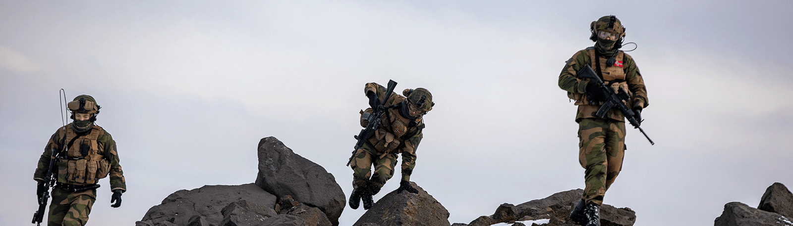 Soldater som går rundt i steinete terreng